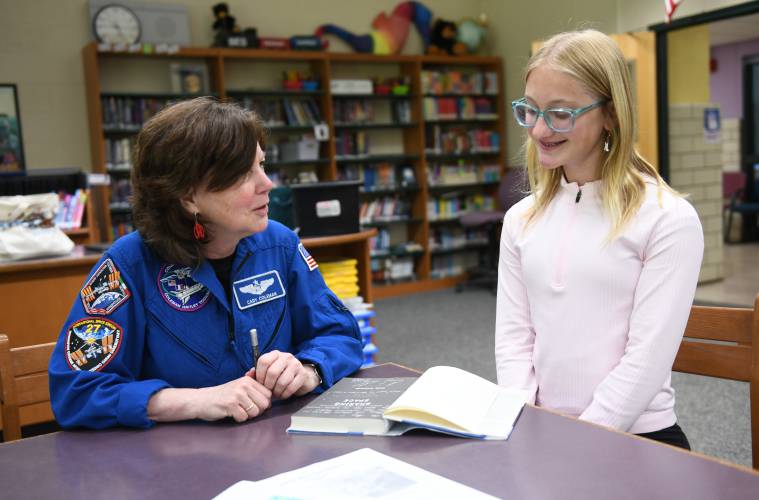 Cady Coleman of Shelburne, a former NASA astronaut, signs her book “Sharing Space” for Amy VanDoren whose efforts brought a Moon Tree to Bernardston Elementary School where she went.